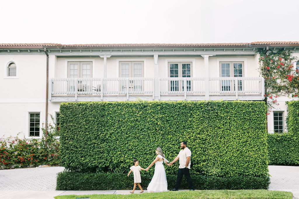 Family of three walking at Worth Avenue