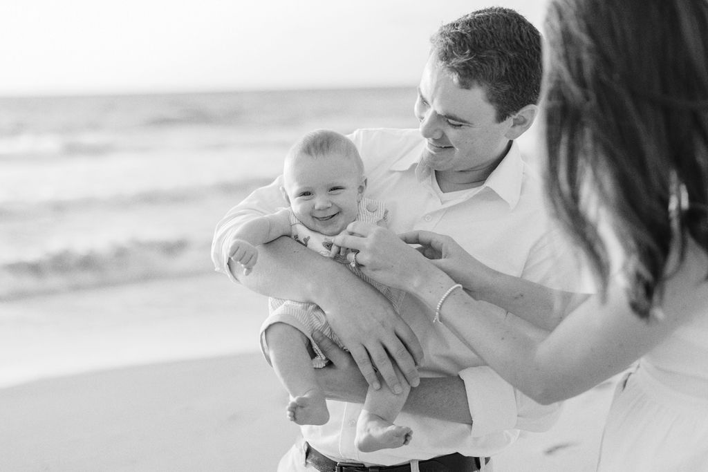 dad holding baby while mom tinkles him 