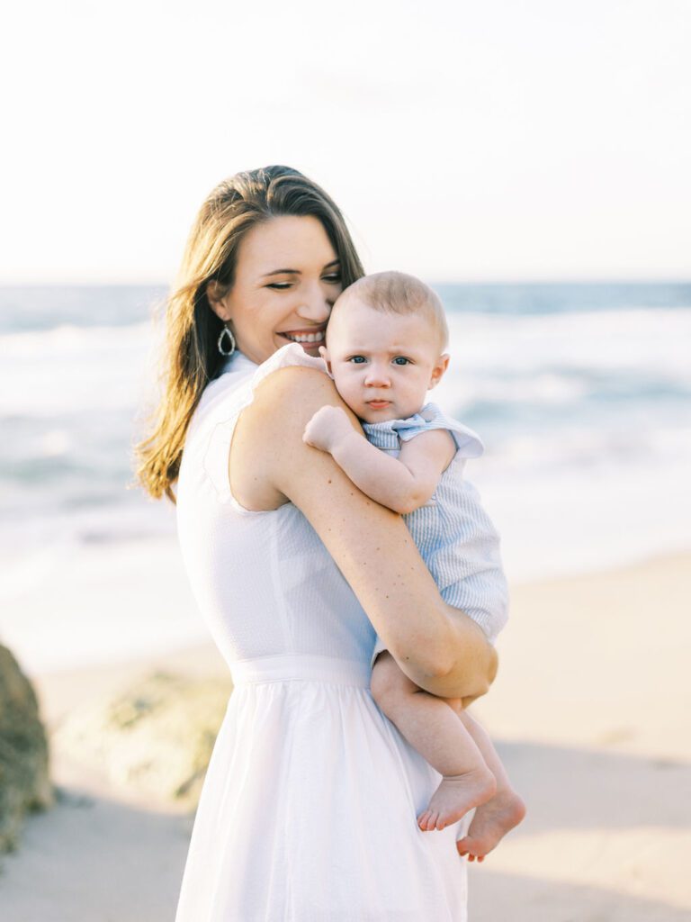 Mom and baby son hugging in Beach family session