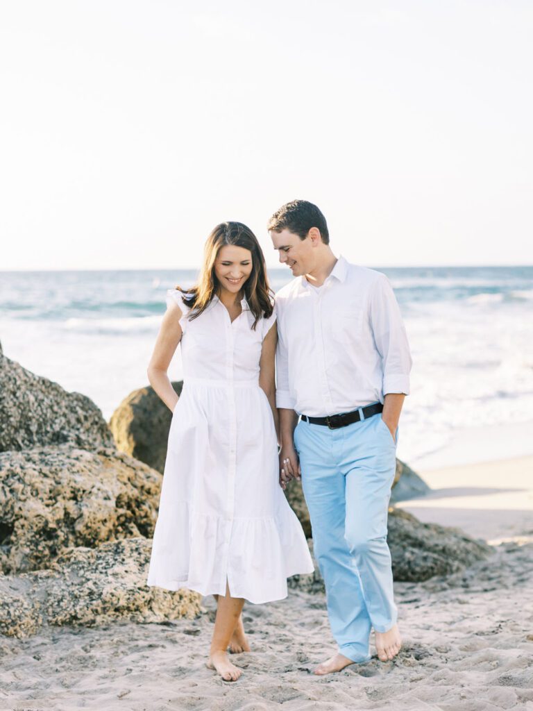 Couple walking and holding hands in Boca Raton Beach