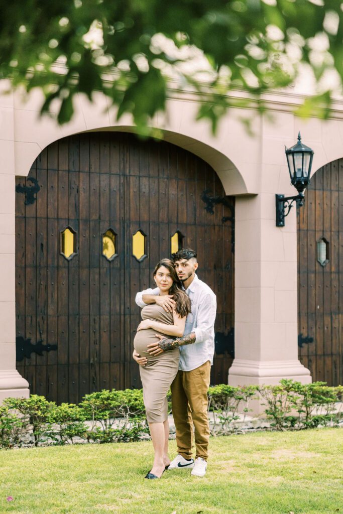 couple hugging in maternity session in worth avenue