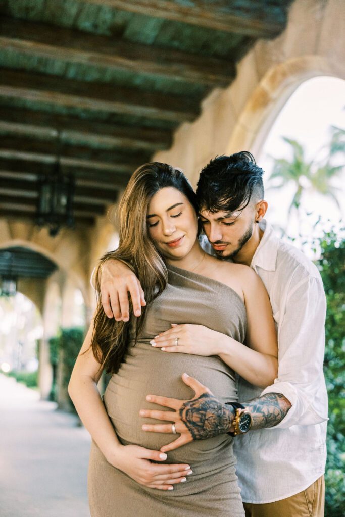 Couple hugging maternity belly