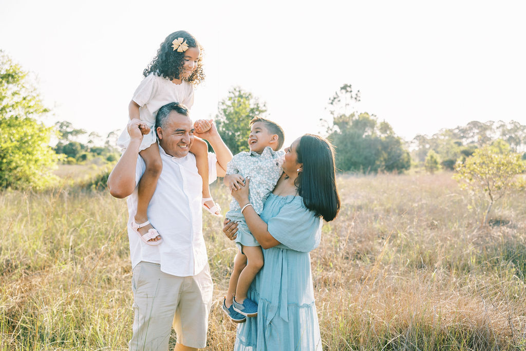 Family of 4 smiling at each other at Crestwood Park in west palm beach fl
Little Ones Laughing During a Family Session